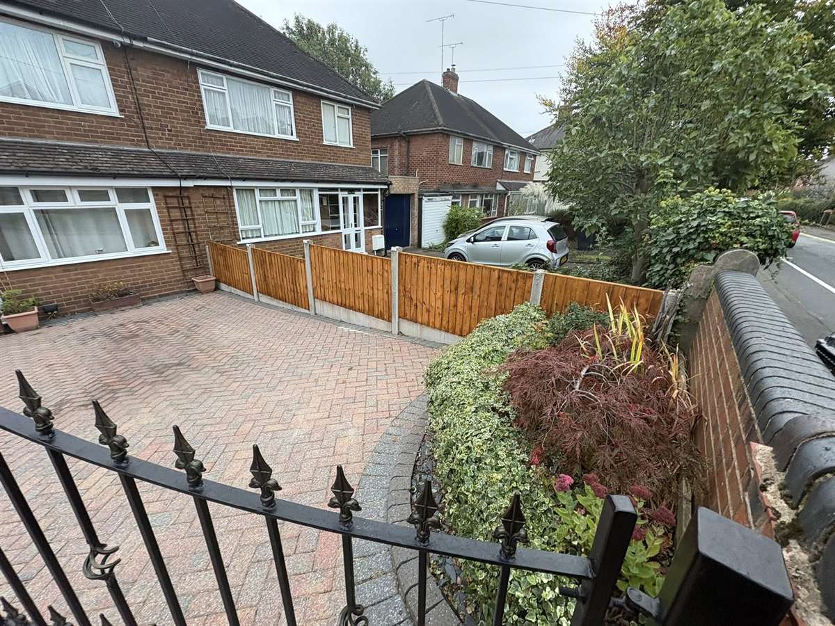 Herringbone block-paved driveway and new fencing at a West Midlands home